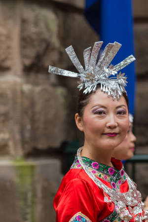 Sydney, Australia - March 25, 2017: Head shot of Chinese woman living in Australia welcomes Chinese Premier Li Kequing with traditional dances, songs and music. Public square side of Town Hall.のeditorial素材