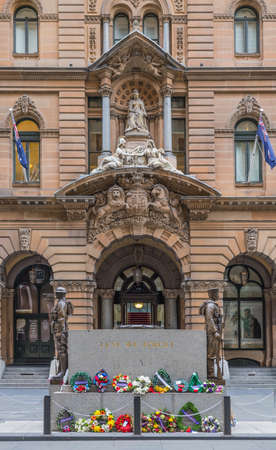 Sydney, Australia - March 25, 2017: Cenotaph War Memorial at Martin Place. Backed by brown facade and monumental statue of Queen Victoria above entrance to historic building, now Shopping mall.のeditorial素材
