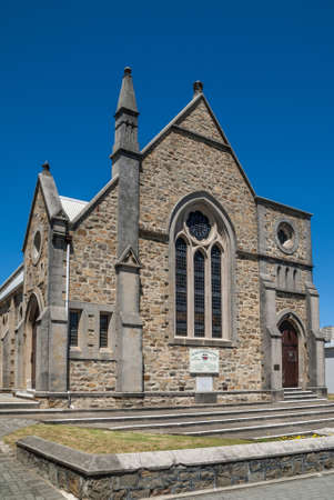 Albany WA, Australia - November 23, 2009: Scots Church part of Uniting church in Australia. Gray and Brown stone building with spire against solid blue sky on Duke Street.のeditorial素材