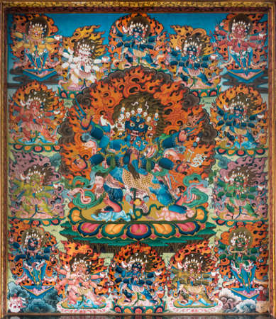 Coorg, India - October 29, 2013: Inside Padmasambhava Vihara of Namdroling Buddhist Monastery. Hell two: Devi Kali feet trampling humans. Vivid colors. Fire and skulls.のeditorial素材