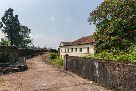 Madikeri, India - October 31, 2013: Walkway and defensive wall on top of ramparts of fort. Green...