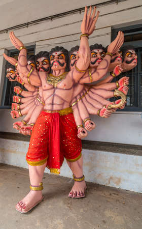 Madikeri, India - October 31, 2013: Full orange body with twenty arms and ten heads Lord Ravana procession doll, on display at Madikeri Fort. Multicolored decorations.のeditorial素材