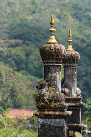 Madikeri, India - October 31, 2013: Turrets on top of Royal mausoleum at Raja tomb. Closeup with base statues of bull. Green hills in back. Shot on roof.のeditorial素材