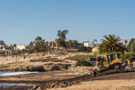 Santa Barbara, United States - Febriary 16, 2018: Bulldozer pushes off-flooding dirt from Montecity...