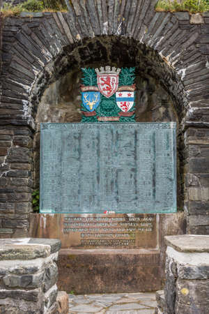 Dornie, Scotland - June 10, 2012: Closeup of WW1 war memorial outside wall of Eilean Donan Castle. Emblems and list of in Flanders fallen soldiers.のeditorial素材