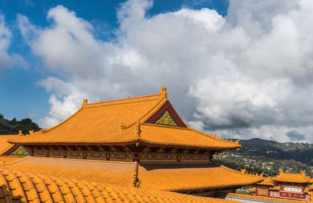 Hacienda Heights, CA, USA - March 23, 2018: Red ochre roof structure of Hsi Lai Buddhist Temple under heavy cloudscape.のeditorial素材
