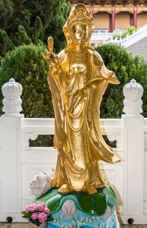 Hacienda Heights, CA, USA - March 23, 2018:  Golden statue of Avalokitesvara Bothisattva, Guanyin, with willow twig on side of garden at Hsi Lai Buddhist Temple.のeditorial素材