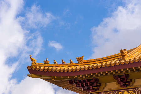 Hacienda Heights, CA, USA - March 23, 2018: Red ochre roof structure of Hsi Lai Buddhist Temple under blue-white cloudscape. Corner tip with figurine decoration.のeditorial素材