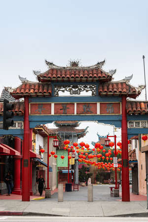 Los Angeles, CA, USA - April 5, 2018: Red traditional wooden entrance gate to central plaza of Chinatown. Plenty of red balloons strung over walkways. Traditional buildings.のeditorial素材