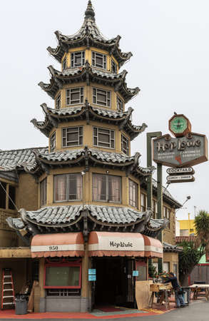 Los Angeles, CA, USA - April 5, 2018: Pagoda of HopLouie bar in cental Chinatown against silver sky. Carpenter working on the side.のeditorial素材