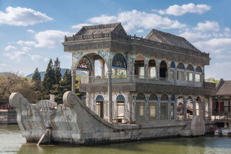 Beijing, China - April 29, 2010: Summer Palace. Closeup of gray marble pleasure boat with a few painted decorations docked at lake. Under blue sky with white clouds.のeditorial素材