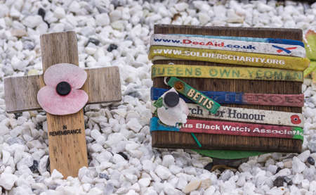 Lochander, Scotland - June 11, 2012: Cross and honour bands commemorative items left at Commando...