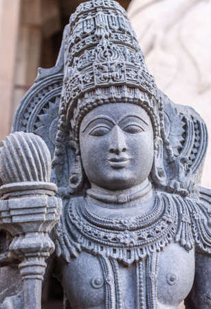Shravanabelagola, Karnataka, India - November 1, 2013: Closeup of torso of blue-gray granite statue...