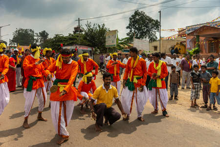 Mellahalli, Karnataka, India - November 1, 2013: Karnataka Rajyotsava Parade. Group of orange and...