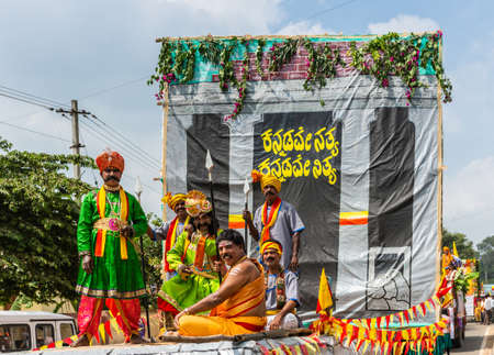 Mellahalli, Karnataka, India - November 1, 2013: Karnataka Rajyotsava Parade. Six men display traditional colorful clothes from different regions in the State under the slogan Kannada for ever.のeditorial素材