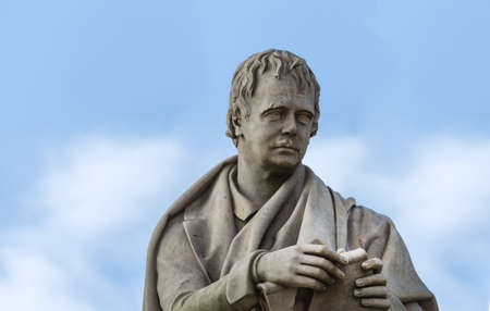 Edinburgh, Scotland, UK - June 13, 2012: Closeup of Sir Walter Scott torso and face against blue sky, as part of larger statue in Scott Monument.のeditorial素材
