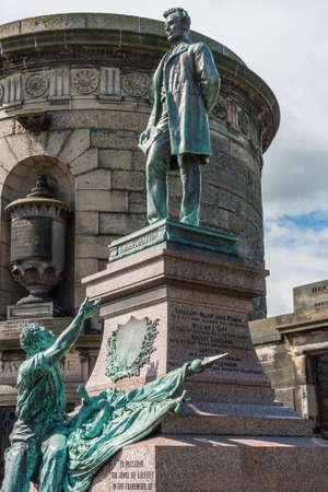 Edinburgh, Scotland, UK - June 13, 2012: Abraham Lincoln bronze statue with surrounding brown stone tombs on Old Calton Cemetery. Blue sky with white clouds.のeditorial素材