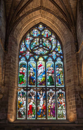 Edinburgh, Scotland, UK - June 13, 2012; St Giles Cathedral. Stained window behind chancel featuring calvary scene with three people on crosses and ascension scene.のeditorial素材