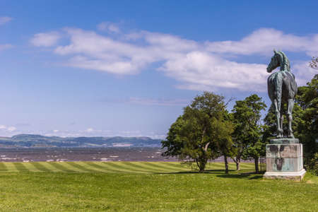 Edinburgh, Scotland, UK - June 14, 2012: Horse statue of King Tom looking at Firth of Forth on green lawn under blue sky at Dalmeny House.のeditorial素材