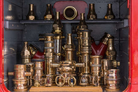 Glasgow, Scotland, UK - June 17, 2012: Closeup of Shining brass connection tools on display at fire truck outside Riverside Museum.のeditorial素材