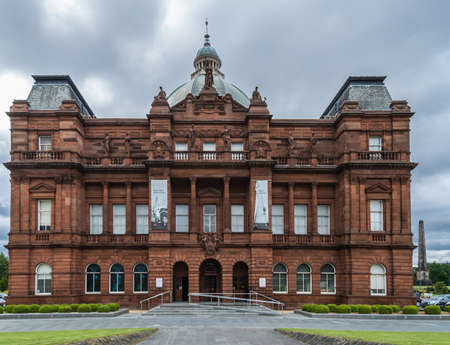 Glasgow, Scotland, UK - June 17, 2012: Red tone Peopleâs Palace and greenish dome at Glasgow Green under heavy cloudscape.のeditorial素材