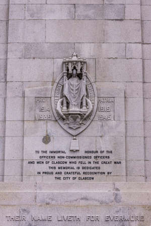 Glasgow, Scotland, UK - June 17, 2012: Closeup of  face of war memorial on George Square remembers the fallen heroes of 2 world wars. Gray stone with statue of bishop.のeditorial素材