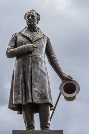 Glasgow, Scotland, UK - June 17, 2012: Closeup of  black bronze James Oswald statue on stone pedestal at George Square against light blue sky. Plenty of Pigeon poop.のeditorial素材