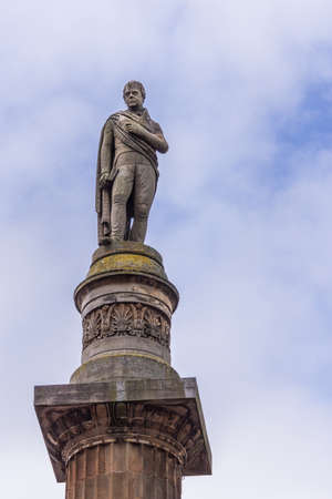 Glasgow, Scotland, UK - June 17, 2012: closeup of Sir Walter Scott stone statue on top of monument and column at George Square against light blue sky.のeditorial素材