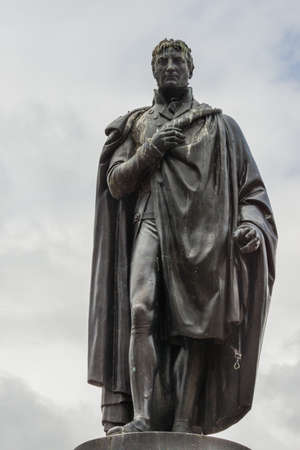 Glasgow, Scotland, UK - June 17, 2012: Closeup of  black bronze Lieutenant-general John Moore statue on stone pedestal at George Square against light blue sky. some Pigeon poop.のeditorial素材