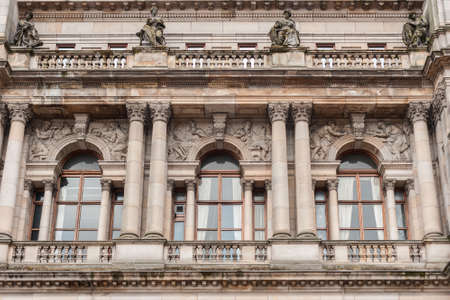 Glasgow, Scotland, UK - June 17, 2012: Detail of facade of Brown stone Glasgow City Chambers building shows windows, balconies, statues and frescoes.のeditorial素材