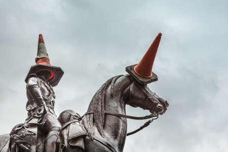 Glasgow, Scotland, UK - June 17, 2012: Closeup of black bronze equestrian statue of Duke of Wellington on Royal Exchange Square in front of Museum of Modern Art. Danger cones on head of man and horse.のeditorial素材