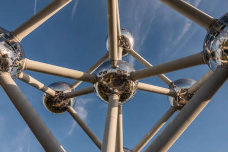 Brussels, Belgium - September 25, 2018: Closeup of six silver shining spheres of the voluminous Atomium monument and tubes against blue sky.のeditorial素材