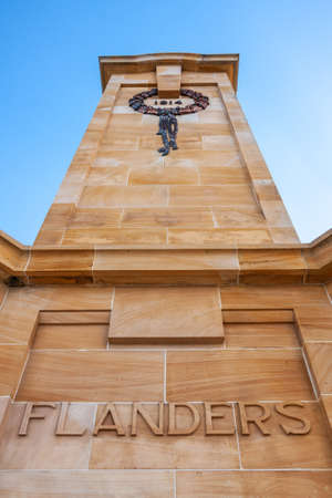 Fremantle, Australia - November 25. 2009: Closeup of Flanders side of brown-beige tower at war memorial under blue sky remembering world war one.のeditorial素材