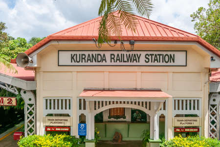 Kuranda, Queensland, Australia - December 4, 2009: Local railway station building with yellow walls and red roof, under white sky and surrounded by green.のeditorial素材
