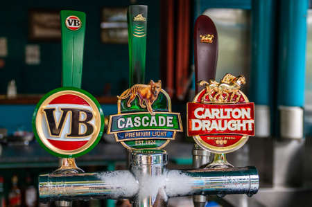Kuranda, Queensland, Australia - December 4, 2009: Closeup of iced beer tap installation with three tap handles of Australian beers, Victoria Bitter, Cascade Premium Light and Carlton Draught.のeditorial素材