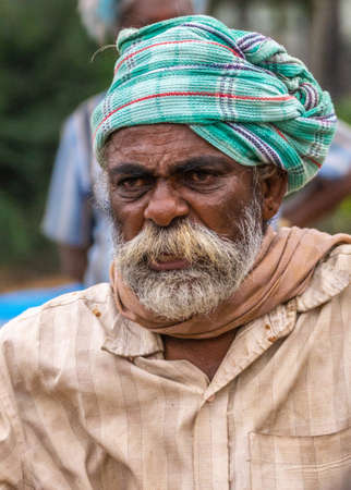 Angadihalli, Karnataka, India - November 2, 2013: Portrait of older man with white and red beard wearing green turban, beige shirt and shawl.のeditorial素材