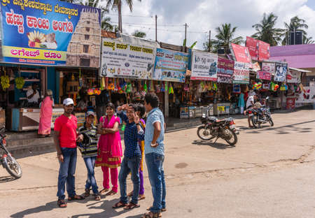 Belur, Karnataka, India - November 2, 2013: View along several shops near main temple shows colorful advertisement banners, merchandise and people.のeditorial素材