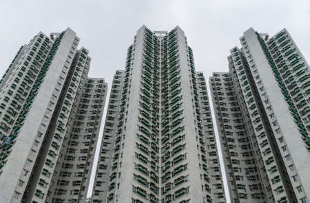 Hong Kong, China  - May 12, 2010: Closeup of some of the Laguna City Blocks development and housing complex. Gray tall highrise building facades under silver sky.のeditorial素材
