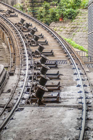 Hong Kong, China  - May 12, 2010: Closeup of the railway out of the bottom station tunnel of The Peak Tram leading to Victoria Peak. Braking technology.のeditorial素材