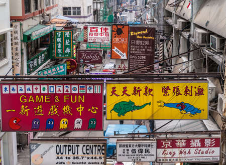 Hong Kong Island, China  - May 14, 2010: Central-Mid-Levels Escalators looks over businesses on Cochrane Street. Overload of colorful billboards and signs in English, Mandarin and Cantonese.のeditorial素材