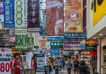 Hong Kong, China  - May 13, 2010: Kowloon mainland Section. Colorful commercial sign, print and lights, English, Mandarin and Kantonese, overkill on Nathan shopping street. Plenty of pedestrians.のeditorial素材