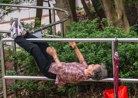 Hong Kong, China  - May 13, 2010: Kowloon Park, Tsim Sha Tsui. Closeup of older graying woman...