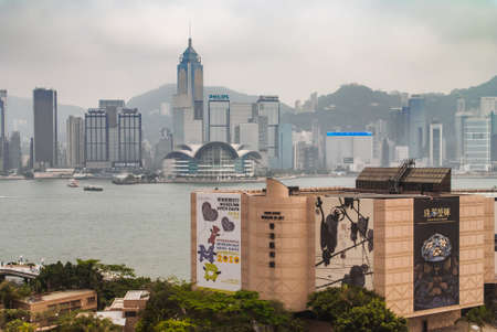 Hong Kong Island, China  - May 12, 2010: Convention Center and Central Plaza Tower with Hong Kong Museum of Art building in front. Victoria Harbour in between. Silver sky.のeditorial素材