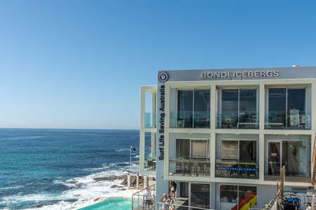 Sydney, Australia - February 11, 2019: Bondi Icebergs Club House and Surf Life Savings with pool. Blue sea and sky. People in photo.のeditorial素材