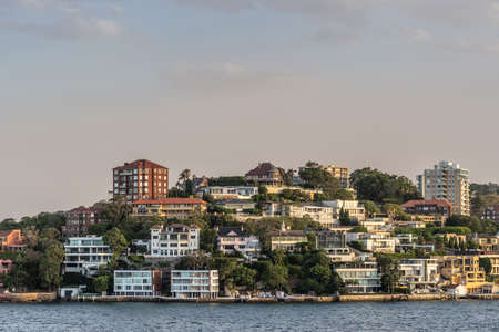 Sydney, Australia - February 12, 2019: Upscale neighborhood around Duff Reserve bordering the bay shows fancy housing under an evening twilight sky.のeditorial素材