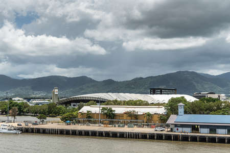 Cairns, Australia - February 17, 2019: Convention Center right behind Cruise Liner Terminal with clock tower. Kuranda National Park mountains under cloudscape.のeditorial素材
