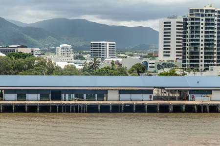 Cairns, Australia - February 17, 2019: The Cruise Liner Terminal along Chinaman Creek. Kuranda National Park mountains under cloudscape.のeditorial素材