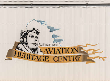 Darwin Australia - February 22, 2019: Emblem of Australian Aviation Heritage Centre painted on the large movable doors of the hangar to let airplanes in and out.のeditorial素材