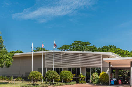 Darwin Australia - February 22, 2019: Military Museum set in green environment under blue sky. Flags in front.のeditorial素材