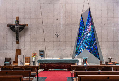 Darwin Australia - February 22, 2019: Inside the modern building of Christ Cathedral shows contemporary shapes, benches, altar and cross. Closeup of chancel.のeditorial素材